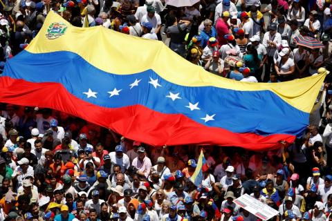 Manifestação nos tempos de Maduro, com grande bandeira do país no centro